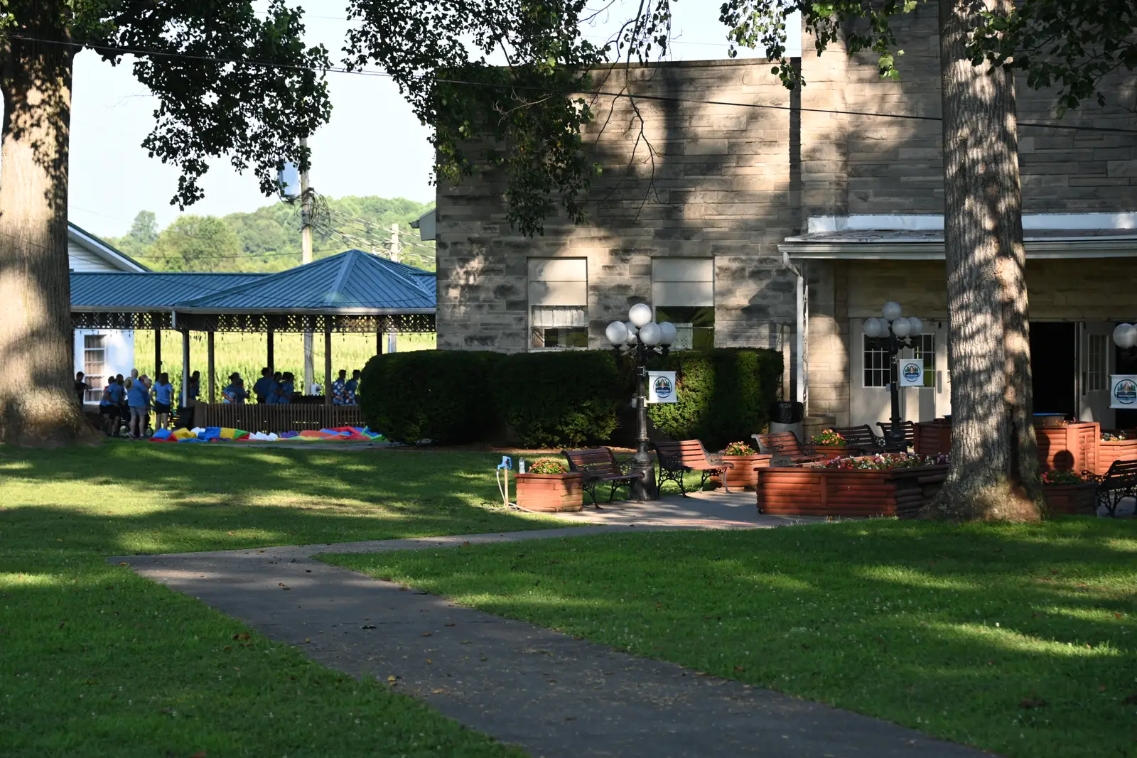 The camp grounds at Orleans — the open-sided tabernacle beyond the lawn, and the stone building with its porch