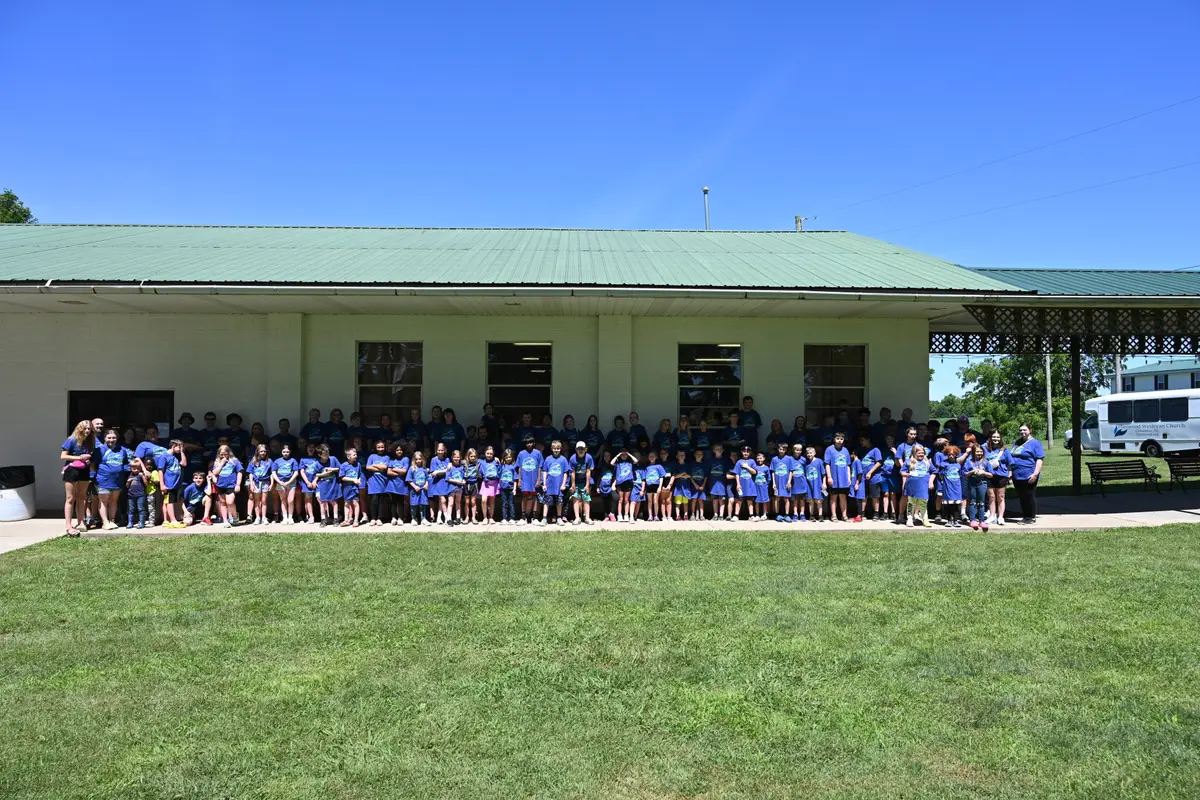 The whole of Kids’ Bible Camp gathered outside in matching camp shirts